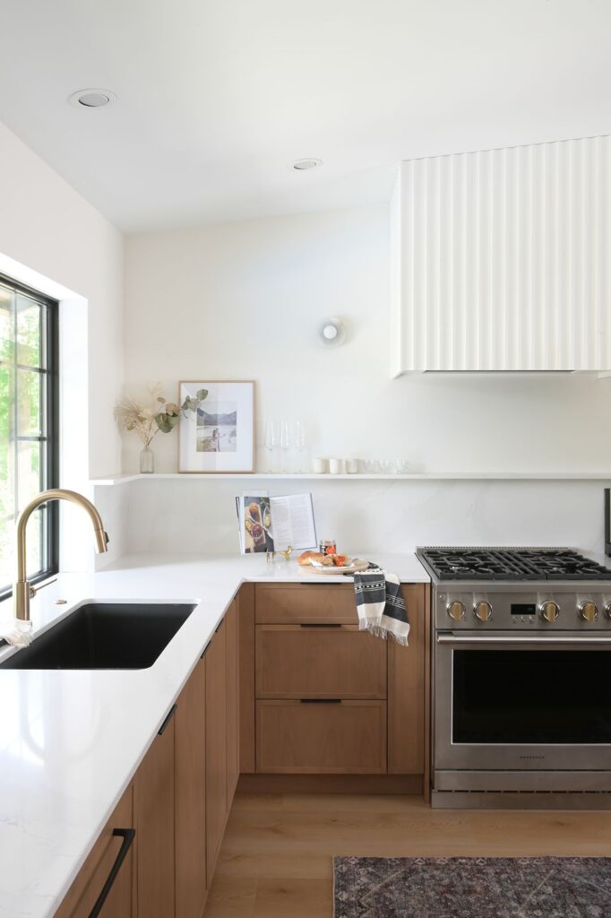 Kitchen with smart storage solutions including pull-out drawers and integrated appliances