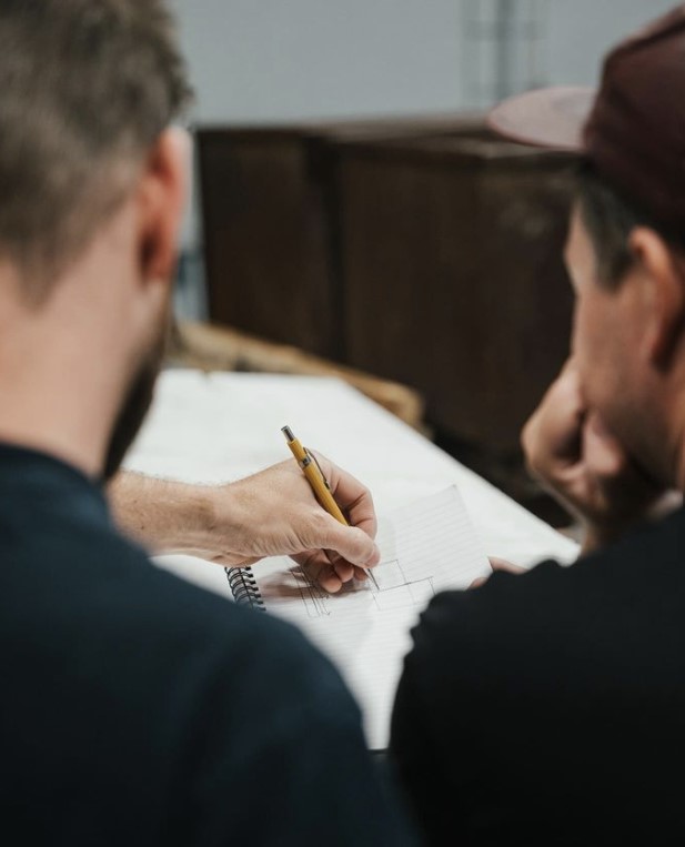 homeowner reviewing plans with contractor- Revel Built Construction