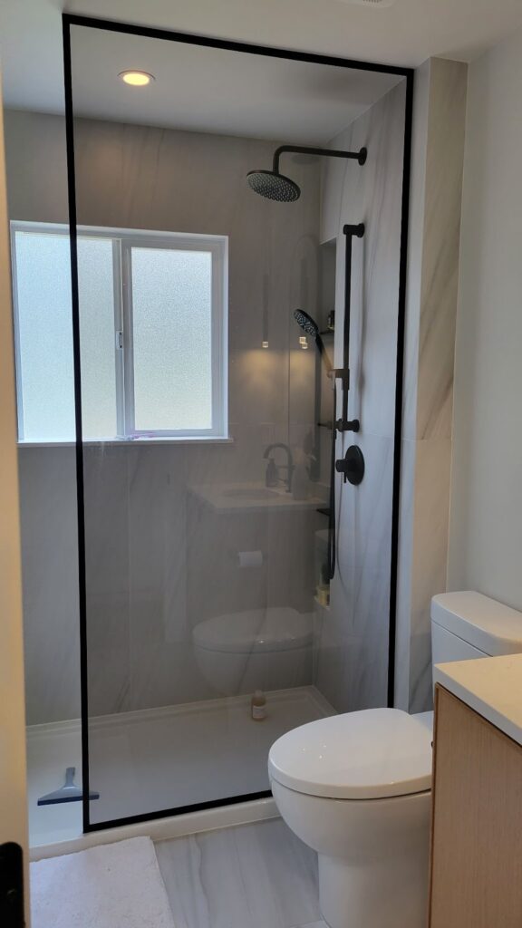 Finished shower featuring glass wall