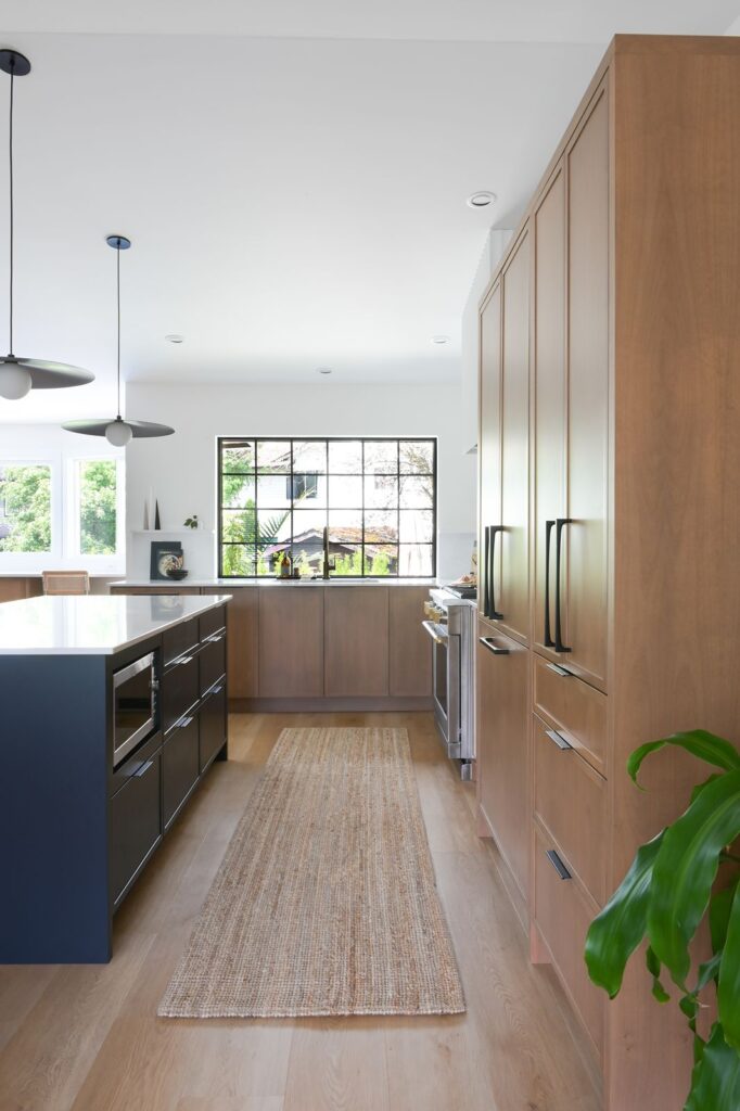 Modern kitchen design black grid windows, oak floors and oak cabinets