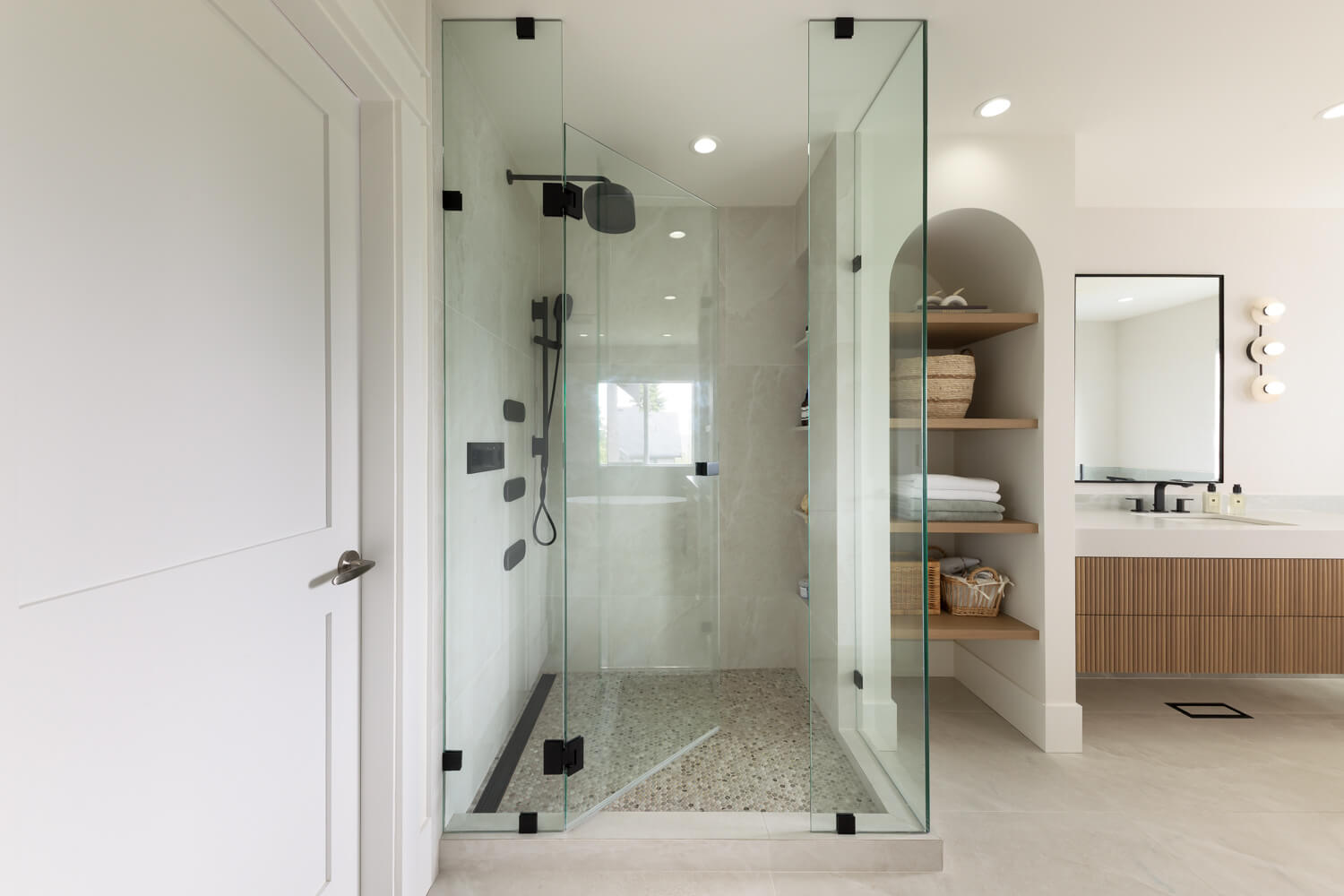 Modern walk in shower with glass enclosure, low curb entry and custom vanity designed by Align Interior Design in Coquitlam BC
