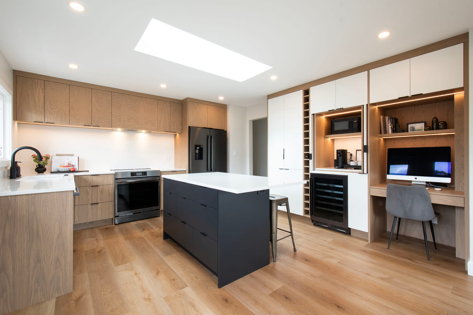 Modern wood kitchen with black island cabinetry and quartz countertops