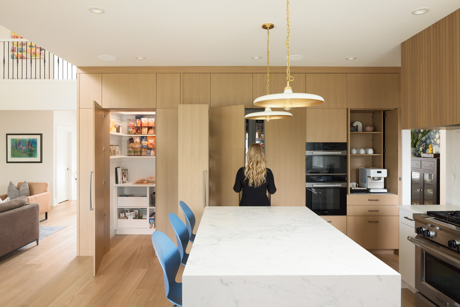 Award-winning contemporary Coquitlam kitchen with concealed pantry, integrated appliances and marble island.