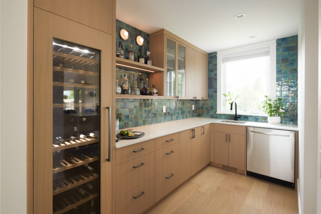 Contemporary home bar in Coquitlam with blue-green tile, wine fridge and warm wood cabinetry