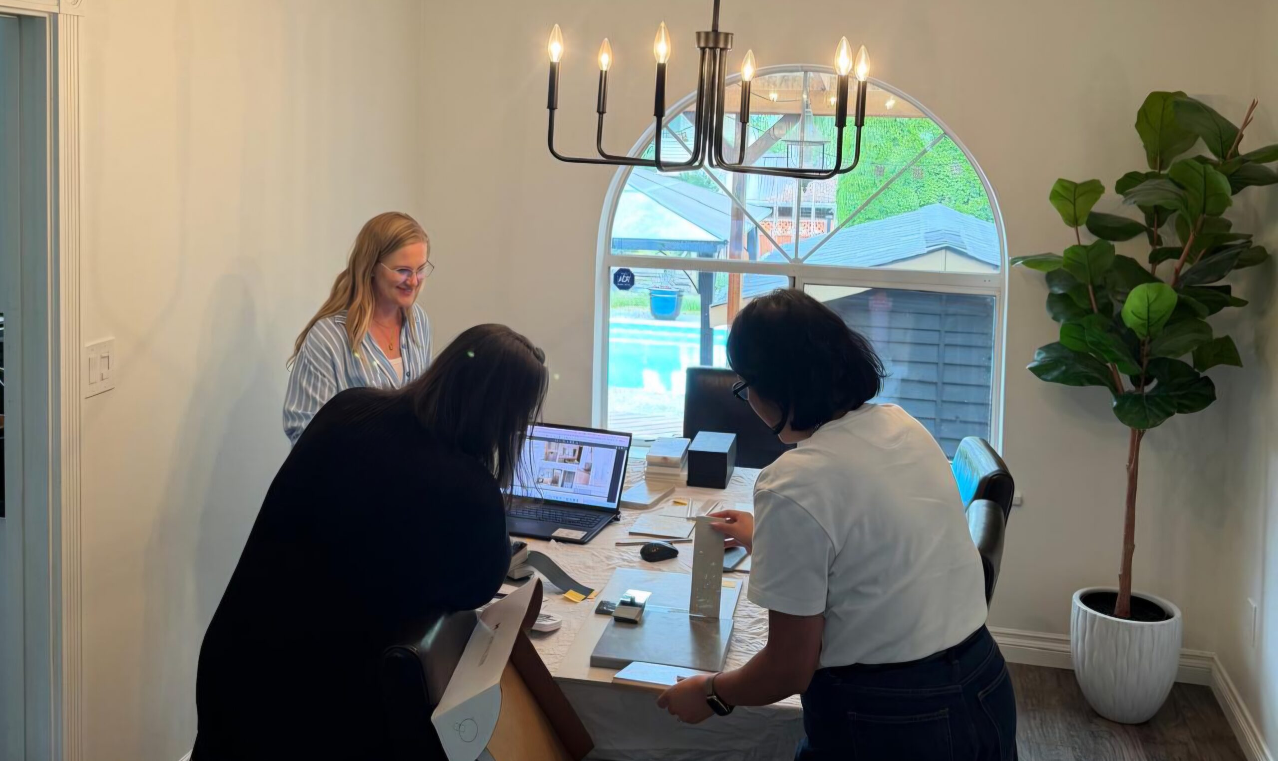 Interior designer reviewing renovation materials and design options with homeowners